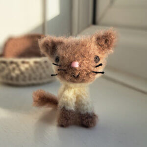 An adorable brown fluffy cat ornament
