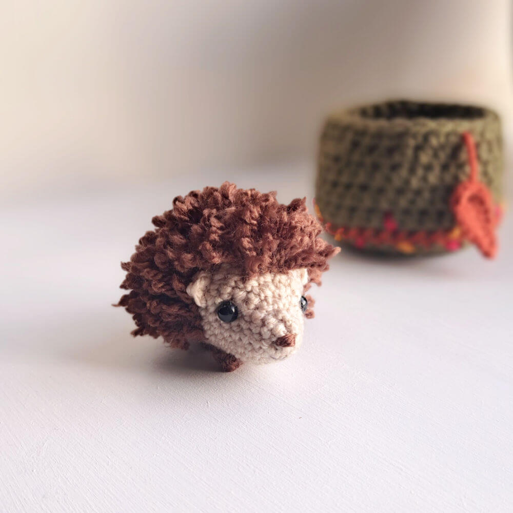 Hedgehog ornament with nest on window sill