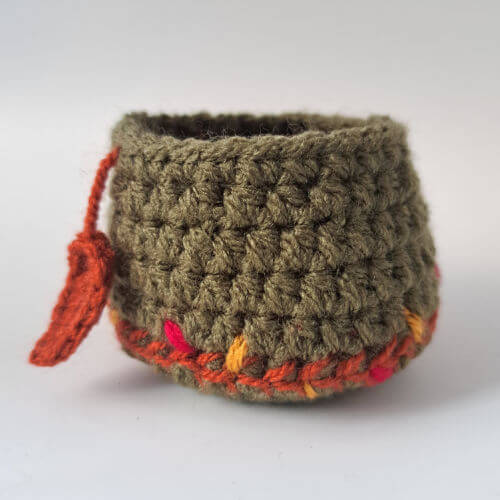 A hand-stitched hedgehog nest with hanging leaf detail
