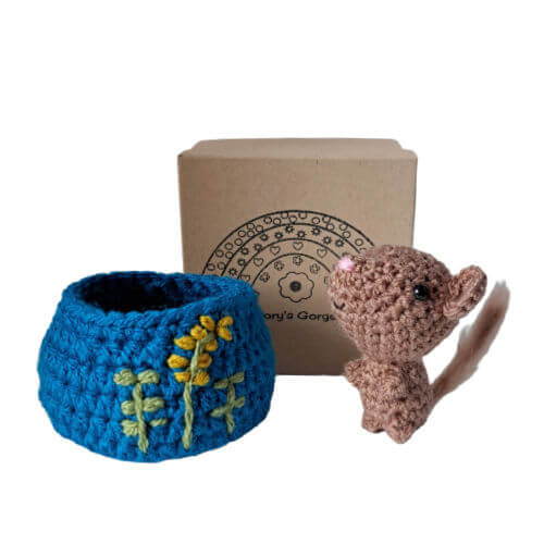 An adorable little brown mouse art figure standing with his embroidered nest and gift box