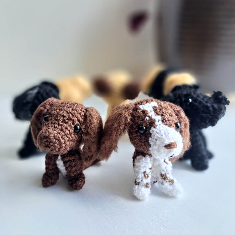Gifts for Dog Lovers set of 7 dog figurines sitting on a window sill the 2 spaniels are at the front
